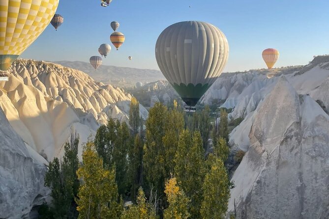 Sunrise Hot Air Balloon Flights in Goreme Valleys - Rose Valley, red rock, and old cave churches
