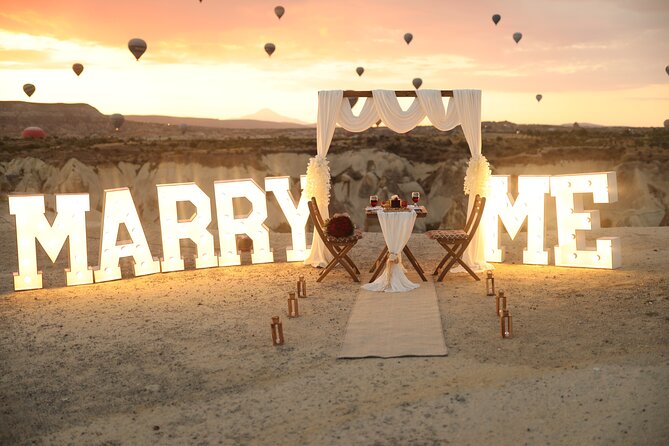 Wedding Proposal and Photoshoot with Hot Air Balloons - The proposal setup with candles and a lit sign